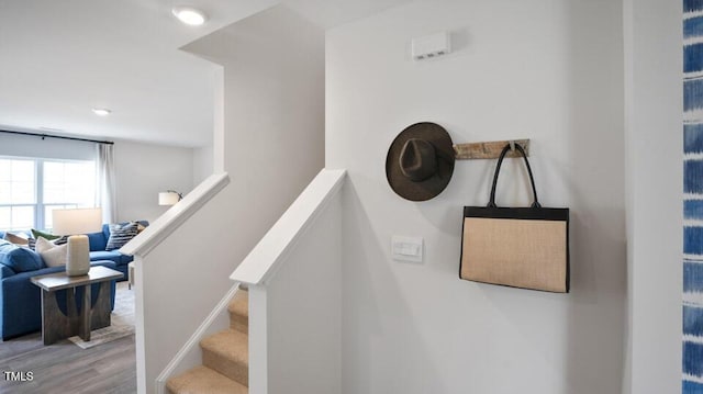 stairs featuring hardwood / wood-style flooring