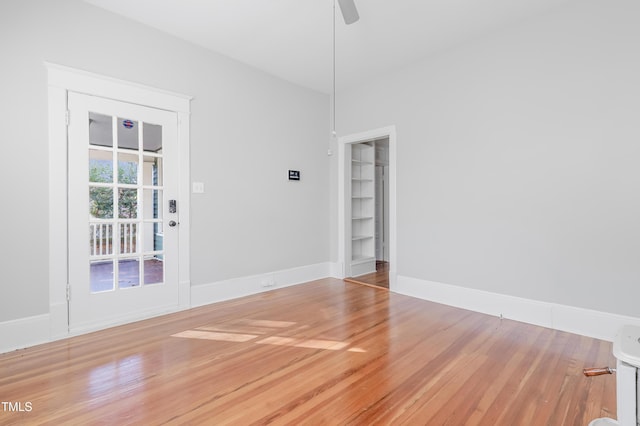 empty room featuring wood-type flooring and ceiling fan