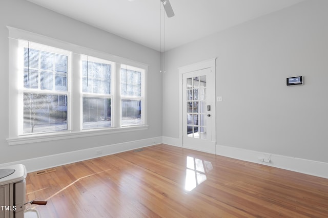 spare room with hardwood / wood-style floors and ceiling fan