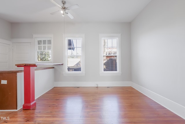 empty room with hardwood / wood-style flooring and ceiling fan