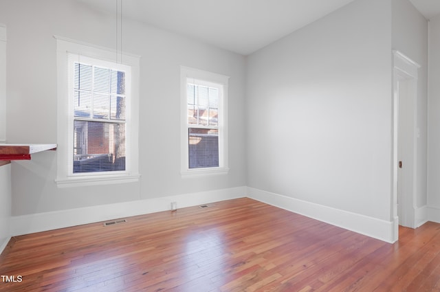 empty room with hardwood / wood-style floors