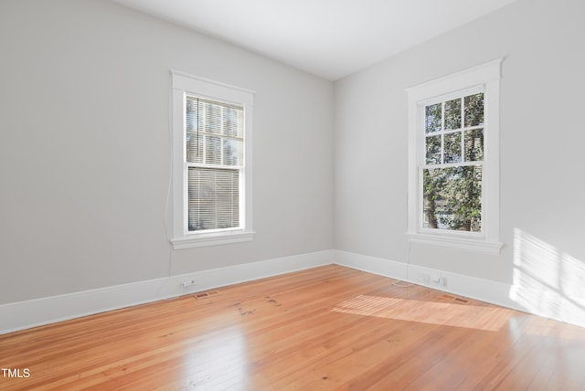 spare room with hardwood / wood-style flooring