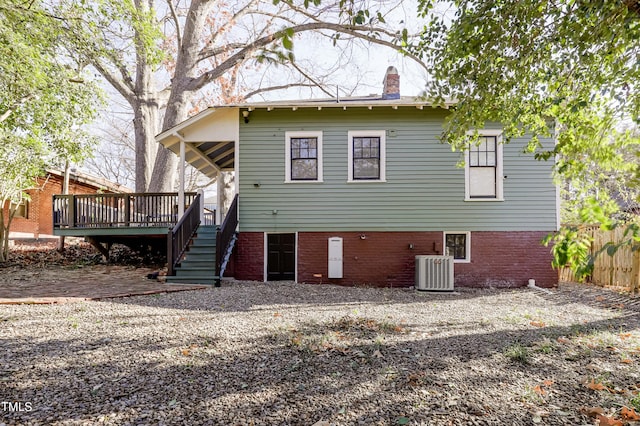 back of house with cooling unit and a wooden deck