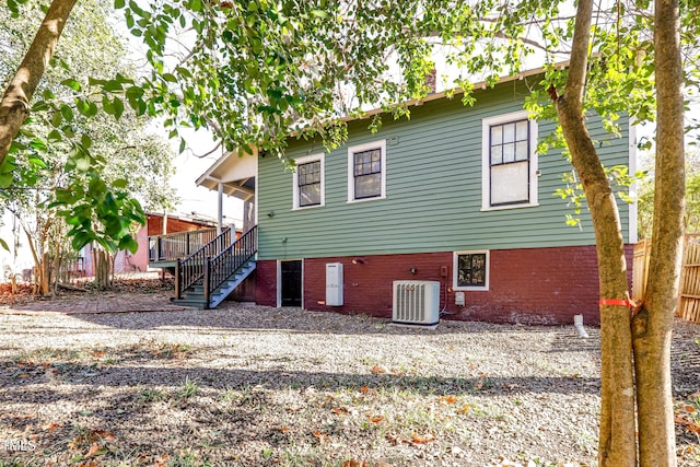 rear view of house featuring central air condition unit