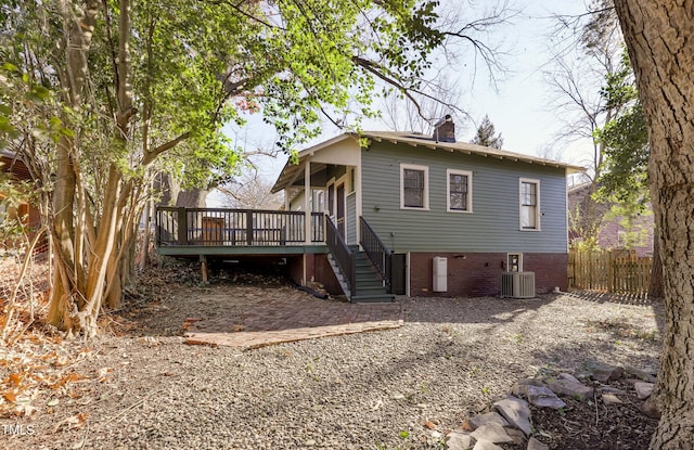 rear view of house with a wooden deck and central AC