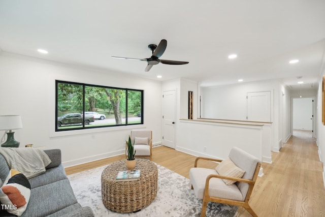 living room with light wood-type flooring and ceiling fan