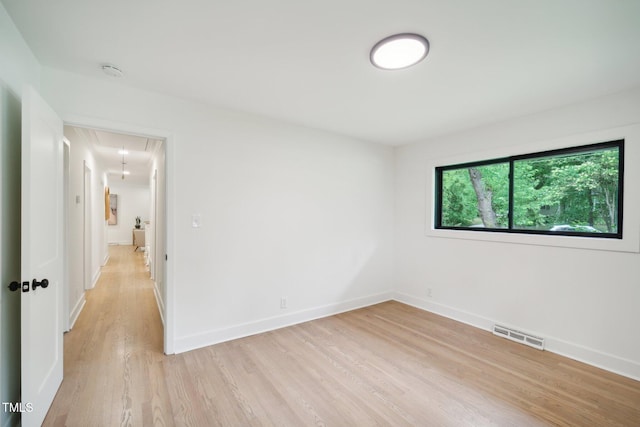 unfurnished room with light hardwood / wood-style floors