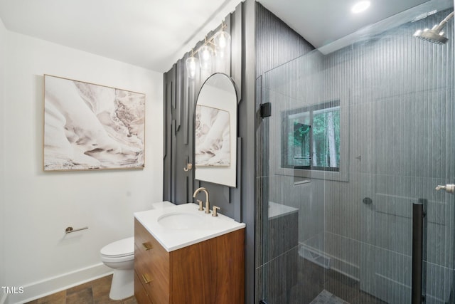 bathroom with a shower with door, toilet, and vanity