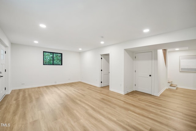 basement with light hardwood / wood-style floors