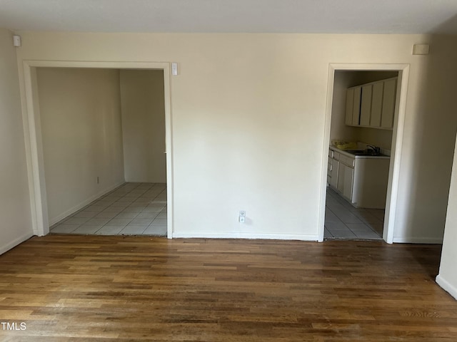 spare room with sink and light wood-type flooring