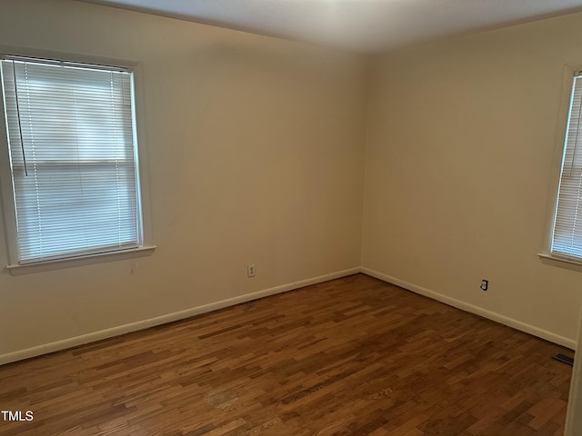 unfurnished room featuring dark hardwood / wood-style floors