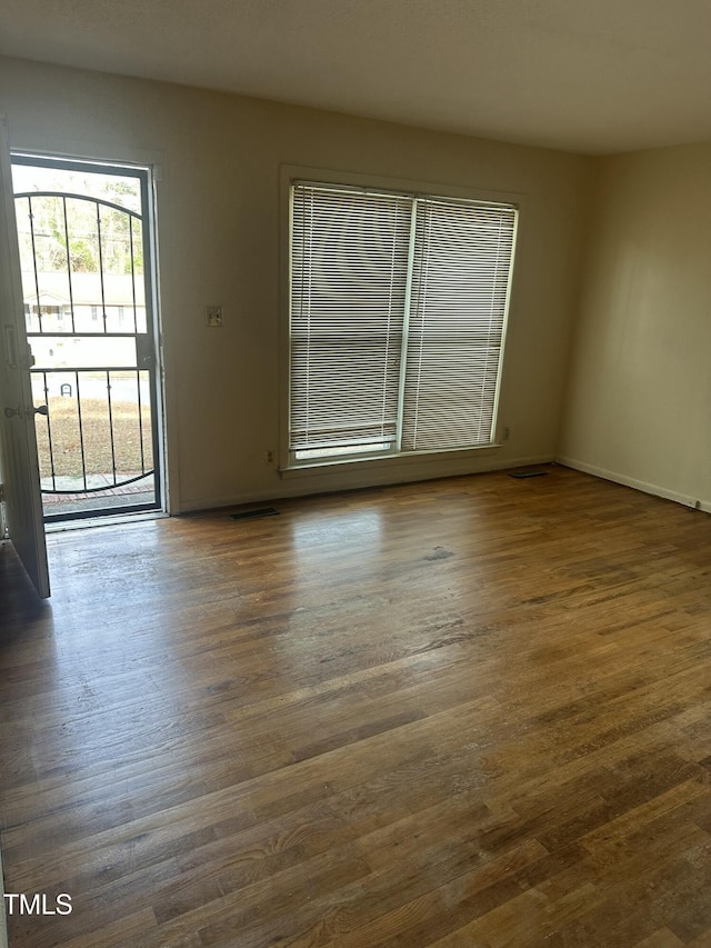 spare room featuring dark hardwood / wood-style flooring