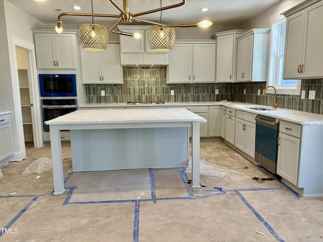 kitchen with pendant lighting, decorative backsplash, appliances with stainless steel finishes, a sink, and light stone countertops