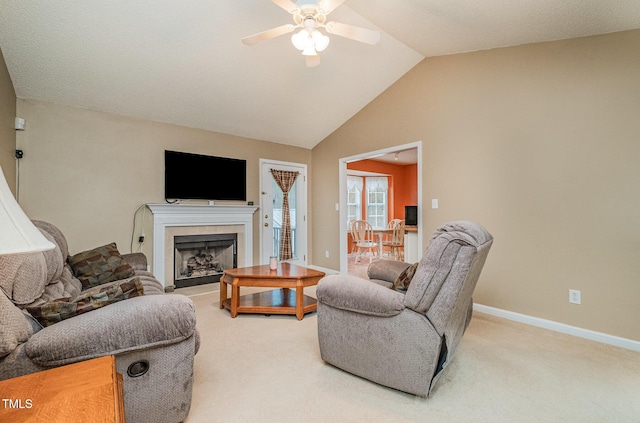 living room featuring ceiling fan, lofted ceiling, and carpet floors