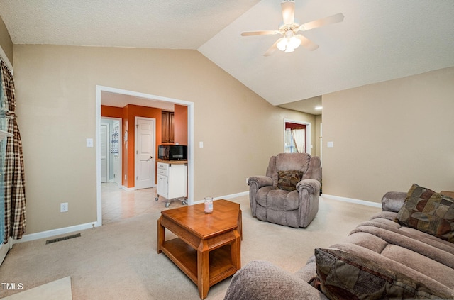 living room featuring light carpet, ceiling fan, and vaulted ceiling