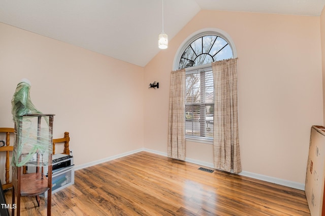 sitting room with hardwood / wood-style flooring and lofted ceiling