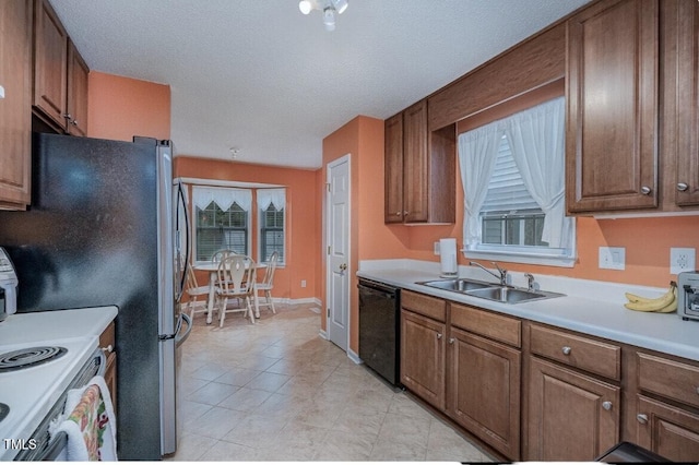 kitchen featuring sink, electric stove, black dishwasher, and a textured ceiling