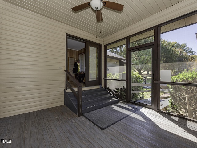 unfurnished sunroom with ceiling fan and plenty of natural light