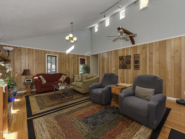 living room featuring a wealth of natural light, track lighting, wood-type flooring, and a textured ceiling