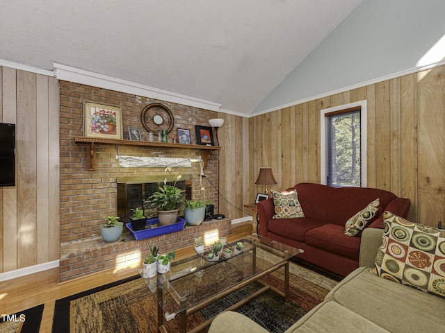 living room featuring hardwood / wood-style flooring, lofted ceiling, a fireplace, and wooden walls