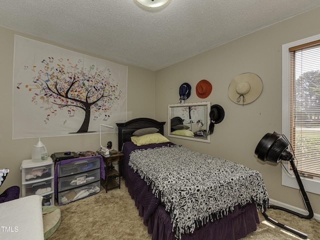 bedroom featuring light carpet and a textured ceiling