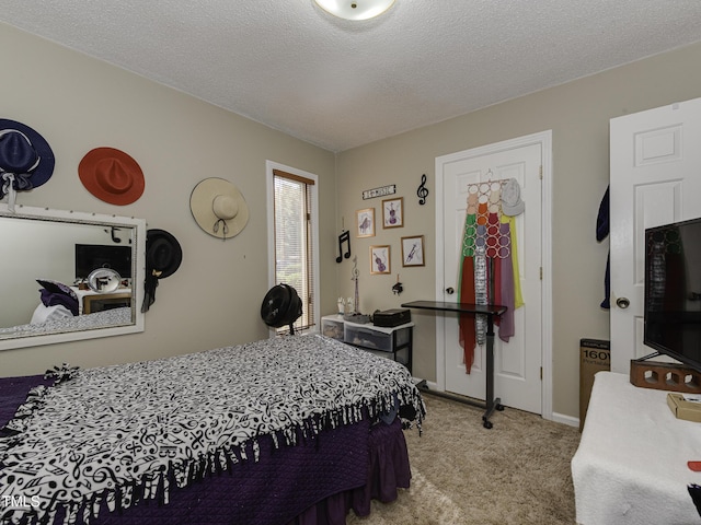 bedroom with a textured ceiling and light carpet