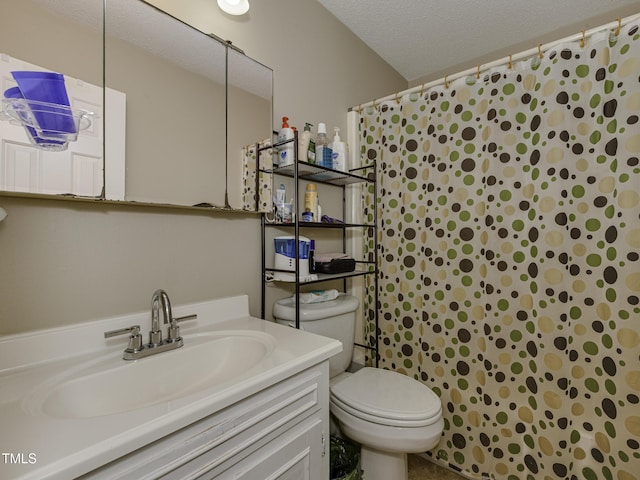 bathroom featuring a shower with curtain, vanity, toilet, and a textured ceiling