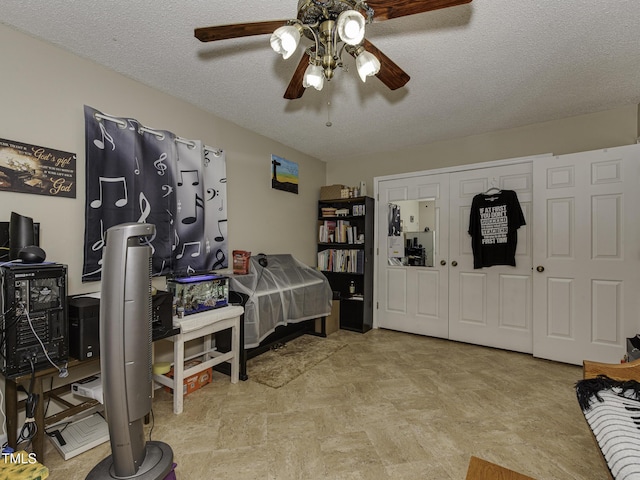 interior space featuring ceiling fan, a textured ceiling, and a closet