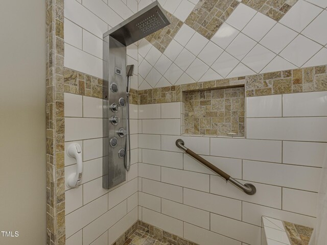 bathroom with tiled shower