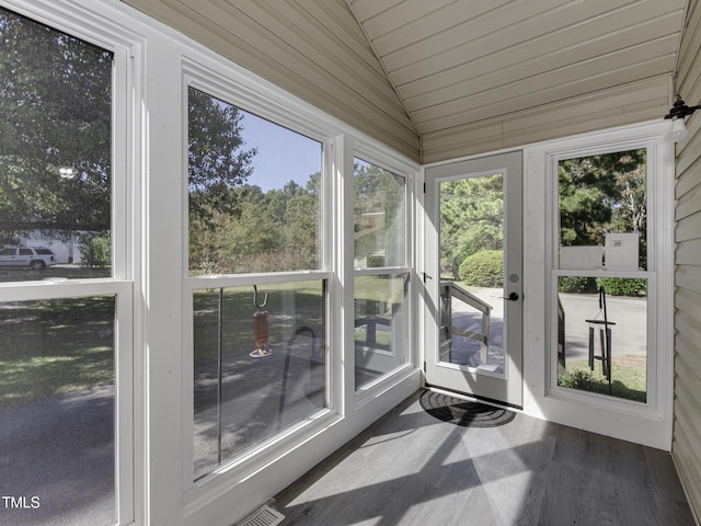 unfurnished sunroom with lofted ceiling