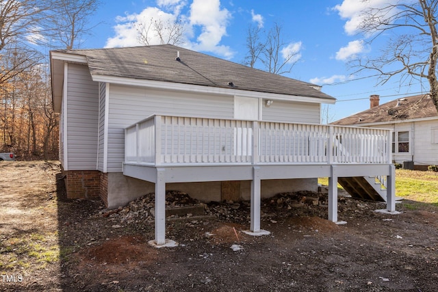 rear view of property featuring a wooden deck