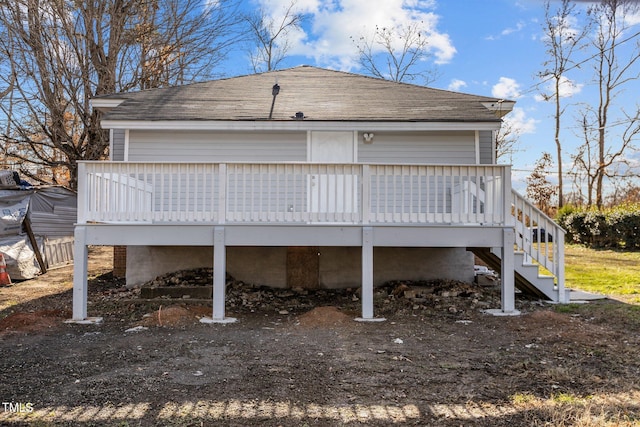 rear view of house featuring a wooden deck