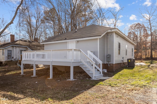 exterior space featuring a wooden deck and central AC