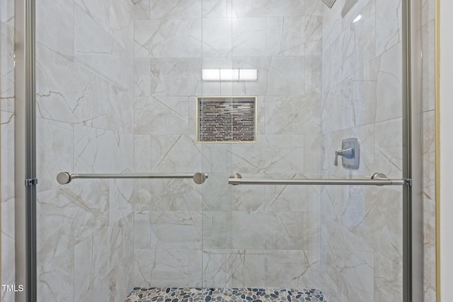 bathroom with a shower with door