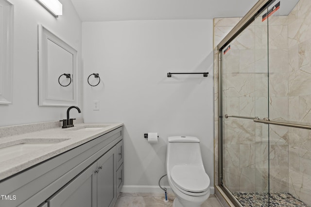 bathroom with vanity, toilet, and a shower with shower door