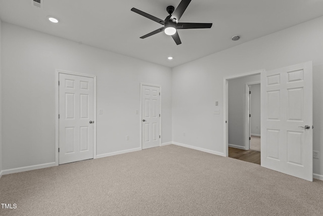 unfurnished bedroom with ceiling fan and carpet floors