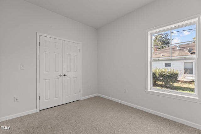 unfurnished bedroom with a closet and carpet