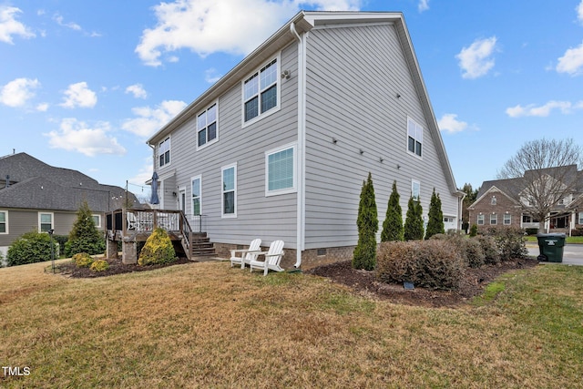 back of property featuring a yard and a deck