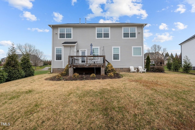 back of property with a deck and a lawn