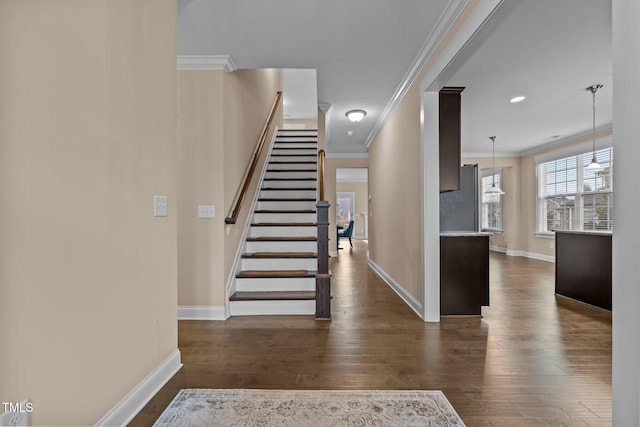 stairs featuring hardwood / wood-style flooring and ornamental molding