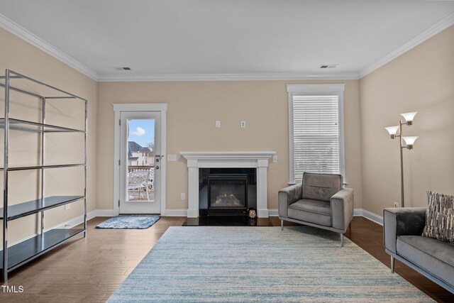 living room with hardwood / wood-style floors and ornamental molding