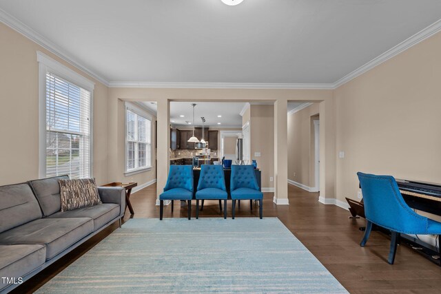 living room with dark hardwood / wood-style flooring and ornamental molding