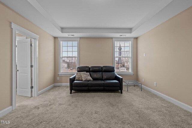 sitting room featuring light carpet and a healthy amount of sunlight