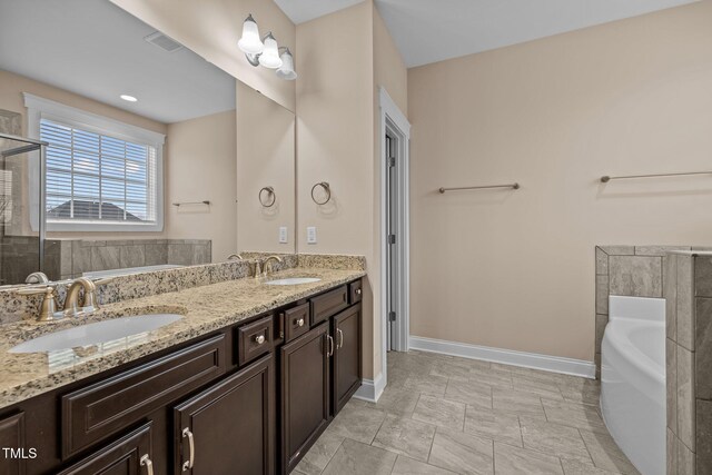 bathroom with vanity and a tub