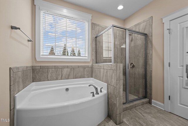 bathroom with shower with separate bathtub