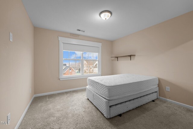 bedroom with light colored carpet