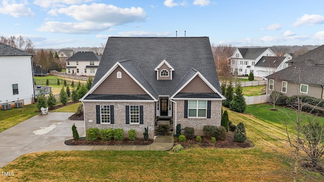 view of front of property featuring central AC and a front lawn