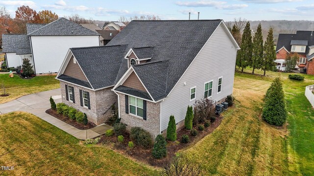 view of home's exterior featuring a lawn and cooling unit