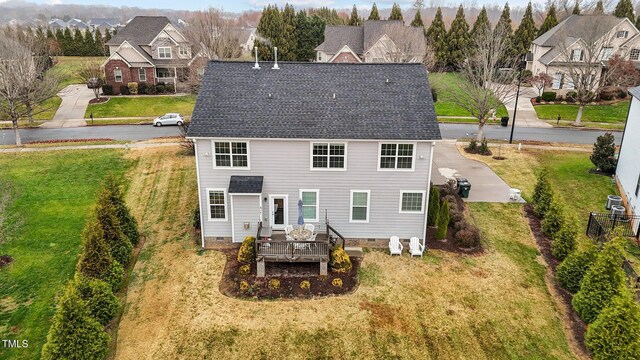 back of property featuring a lawn and an outdoor hangout area