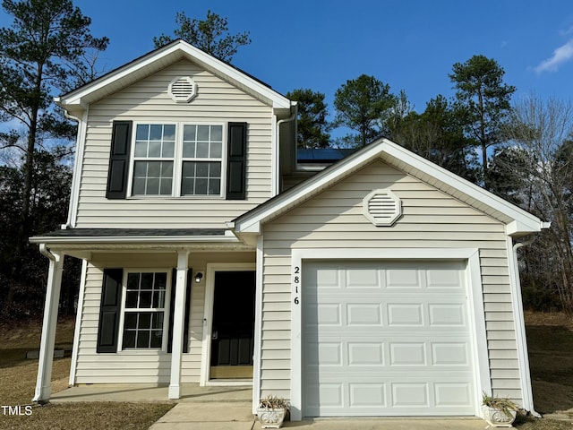 view of property with solar panels and a garage